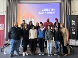 The Generation Listen Leadership Council stands together in the St. Louis Public Radio Community Room during their January 2024 Gen-Listen retreat