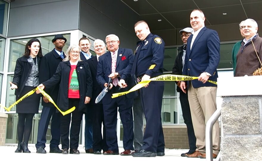 Aldermen join Mayor Pauley (with scissors) & Chief VenHuizen to for the ceremonial crime scene tape cutting.