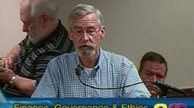 Dan Cofran of Kansas City Citizens Association at microphone, pleased with firefighters labor pact.