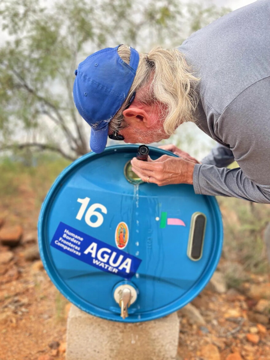 Humane Borders Operations Manager Joel Smith refills a water barrel in the Sonoran Desert.