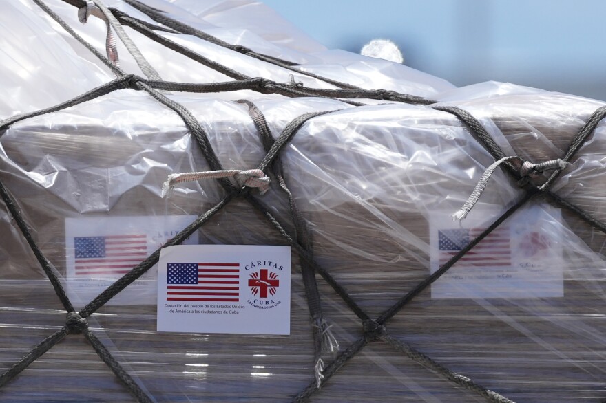 People load pallets containing food and hygiene kits for a humanitarian assistance flight to Cuba organized by the Trump administration as the U.S. continues to put pressure on the island's government, Tuesday, July 21, 2026, in Miami.