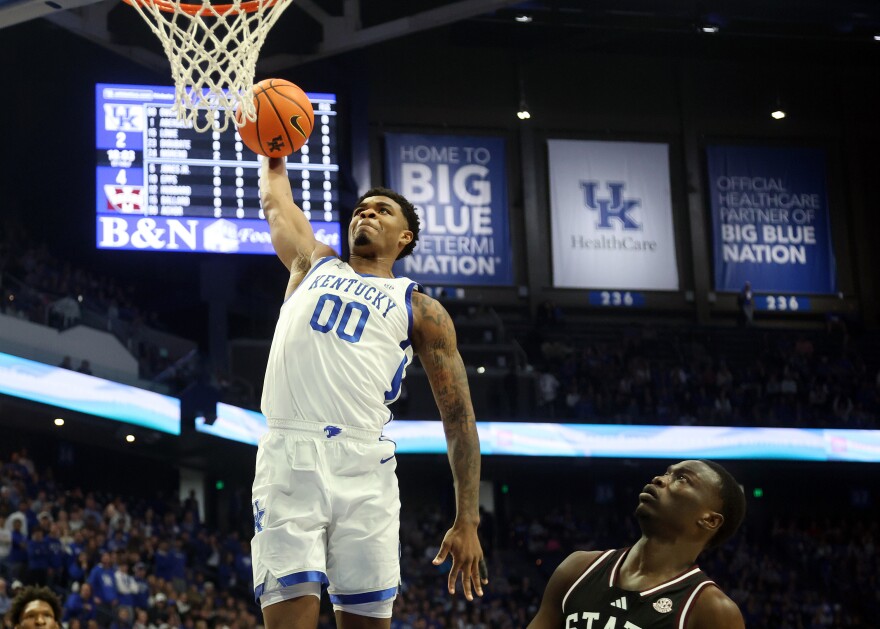 Kentucky's Otega Oweh (00) goes up to dunk as Mississippi State's Achor Achor, right, watches during the first half of an NCAA college basketball game in Lexington, Ky., Saturday, Jan. 10, 2026. (AP Photo/James Crisp)