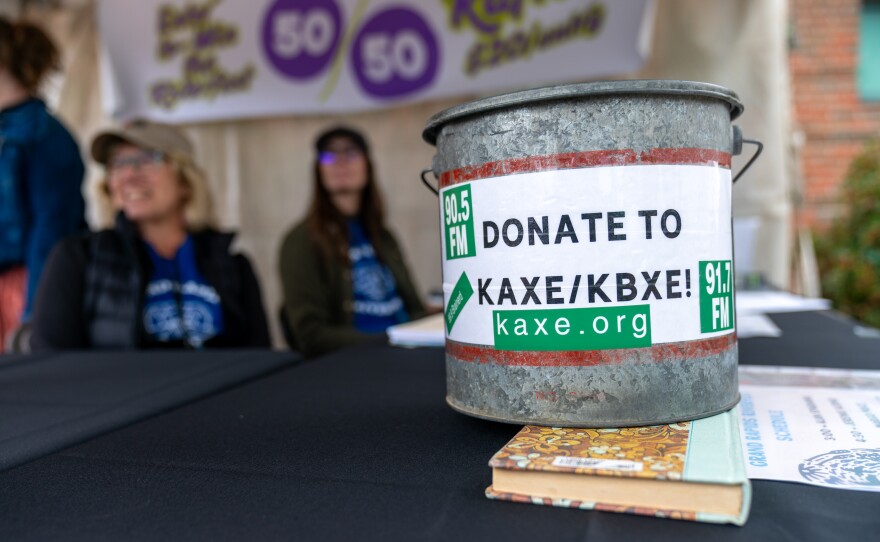 The KAXE donation minnow bucket sits at the raffle booth during Grand Rapids Riverfest on Sept. 6, 2025.