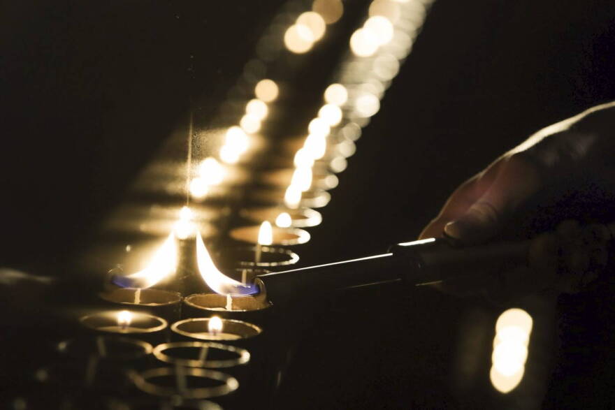 A candle is lit at a ceremony marking the International Holocaust Remembrance Day in the Jewish Museum and Tolerance Center in Moscow, Russia, Friday, Jan. 27, 2017. (Pavel Golovkin/AP)