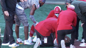 Indiana wide receiver Whop Philyor checks on quarterback Michael Penix as he is attended to by medical personnel after being injured during Saturday's game against Maryland.