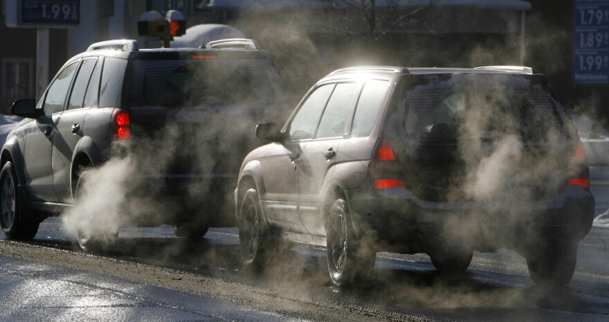 Exhaust comes out of two vehicles on a road