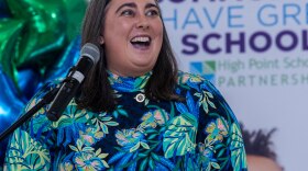 Amanda Cook speaks in front of a microphone