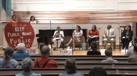 Guilford democratic representatives sit on stage at a town hall about public school funding