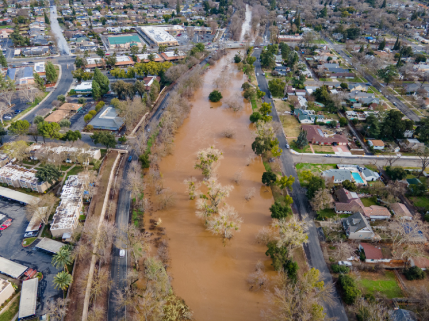 An aerial shot of Bear Creek in Merced is shown after heavy rains in January 2023 resulted in water flooding into residential areas.
