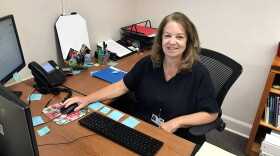 Patti Knapp, who works with teachers to schedule their tutoring slots for Beyond the Bell, at her desk in the Alachua County Public Schools district office. (Amy Galo/WUFT)