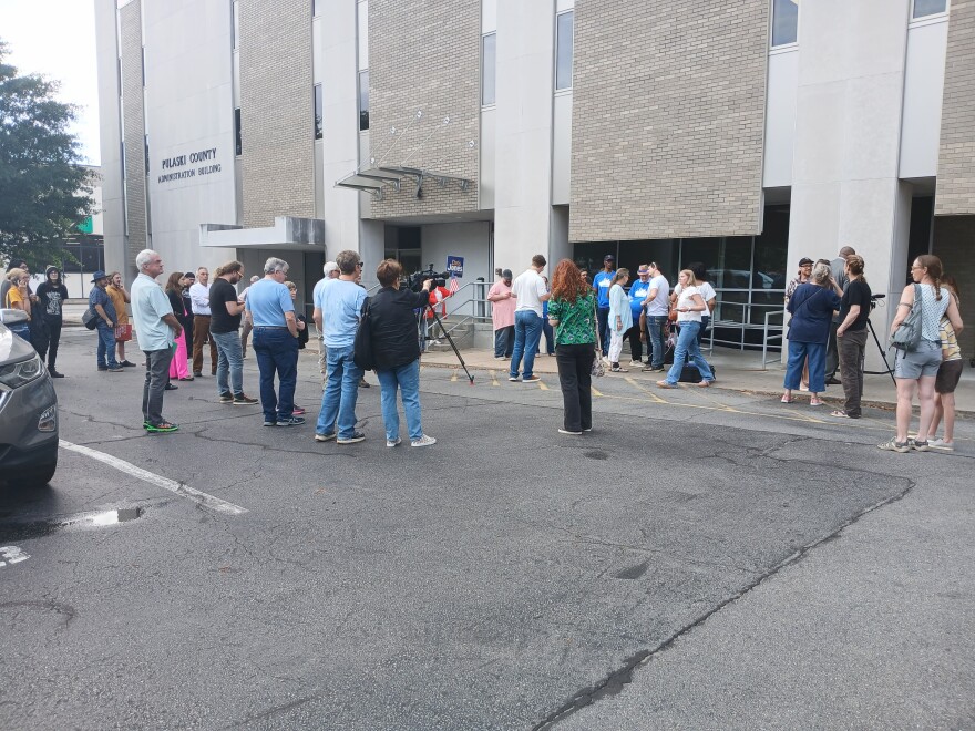 Protesters gather to support year long data center moratorium before a Tuesday quorum court meeting.
