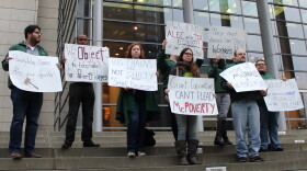 Workers and labor activists demonstrate outside the U.S. District Courthouse in support of the city's $15 an hour minimum wage