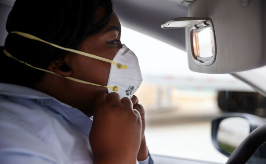 Maryland Cremation Services transporter Morgan Dean-McMillan adjusts her N95 face mask in May 2020 in Silver Spring, Md.
