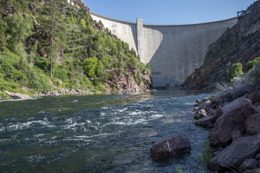 The Green River flows beneath the Flaming Gorge Dam in Utah. After Upper Basin states voted to suspend some water releases from Flaming Gorge Reservoir, Lower Basin states published a letter in response. 