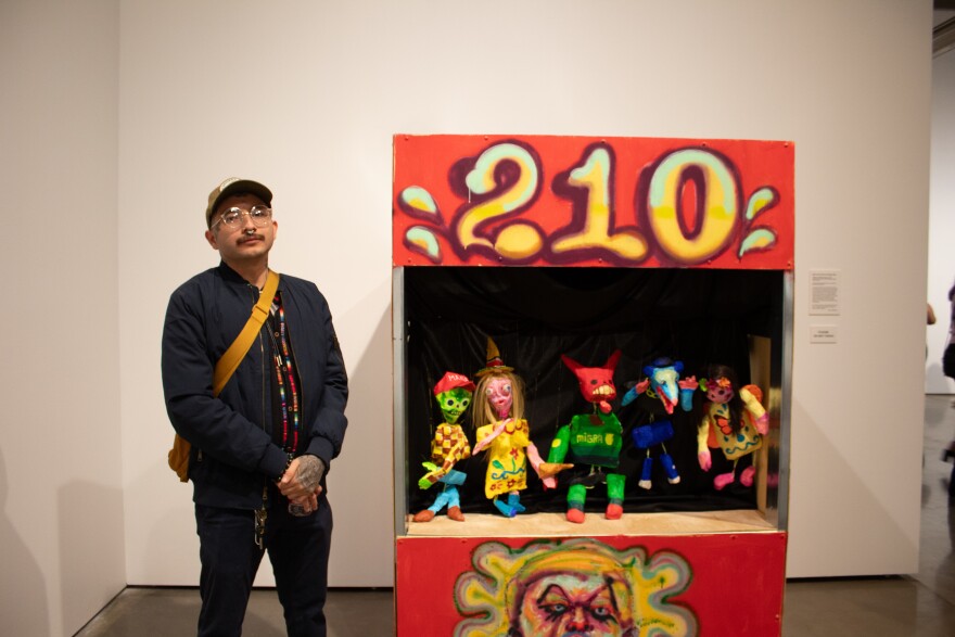Mauro de la Tierra next to the installation he collaborated with Valley Ortiz.