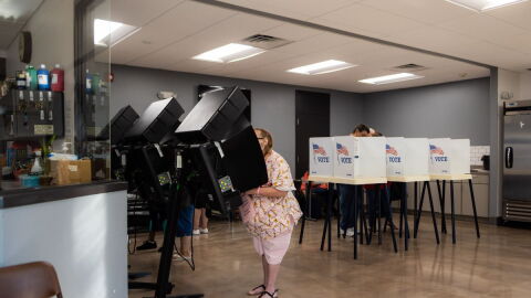 Voters fill out their ballot at a voting booth during the 2022 Kansas primary election at Argentine Community Center in Wyandotte County.
