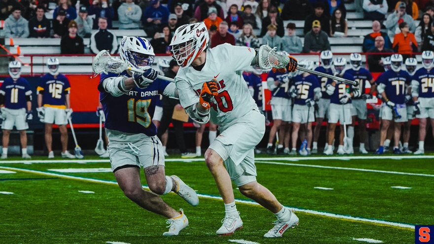 Cole Kirst, (40, white) runs past a defender toward the net