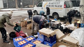 People sort through a selection of free groceries at a Harvest for Hunger giveaway in Snowmass Village on Friday, Nov. 24, 2023. The nonprofit collected about 1,300 pounds of food from grocery stores and bakeries, then augmented it with nearly 500 pounds of nonperishable items collected at a recent food drive.