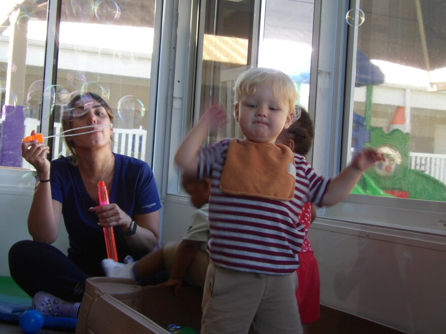 A teacher blows bubbles for toddlers at Children First in Sarasota on Sept. 9, 2026.