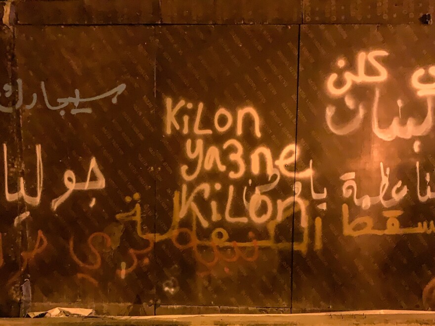 Graffiti showing the words "<em>Kilon Ya3ne Kilon</em>," one of the loudest chants being heard in recent days in Lebanon. It means "All of them means all of them!"