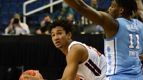 Virginia Tech's Keve Aluma looks to pass around UNC's Day'Ron Sharpe.