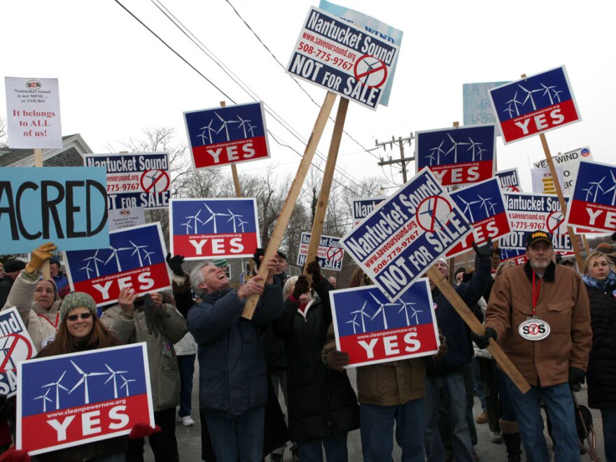 Supporters and opponents of the wind farm project vie to get their message across in Woods Hole, Mass., earlier this month, while Interior Secretary Ken Salazar hosted a news conference.