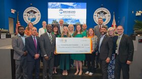 Broward County Public Schools board members and administrators, along with Broward Education Foundation and Bridge2Life, accept a $1.1 million 'Post Secondary Success for All' grant from Helios Education Foundation.