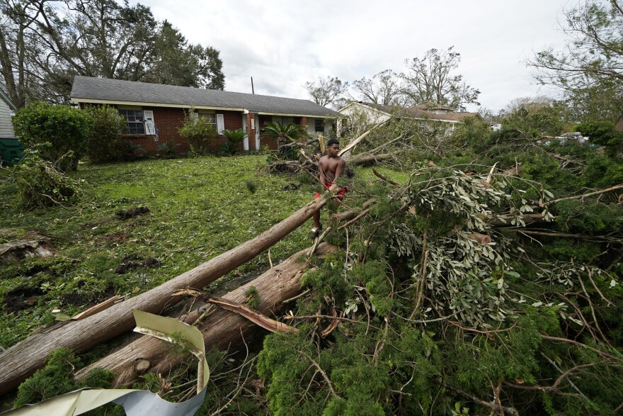 Terrell Berzat helps clear fallen trees for a family member in the aftermath of Hurricane Ida in LaPlace, La., Monday, Aug. 30, 2021. (AP Photo/Gerald Herbert)