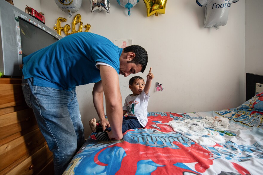 Ferley Sáenz, a 40-year-old coordinator of Bogotá's transportation system, dresses his son Jeronimo for the day. Sáenz admits that his wife assumes most of the child care and household chores. For years, he considered this the norm, spending most of his days at work or with friends. Now he's trying to step up.