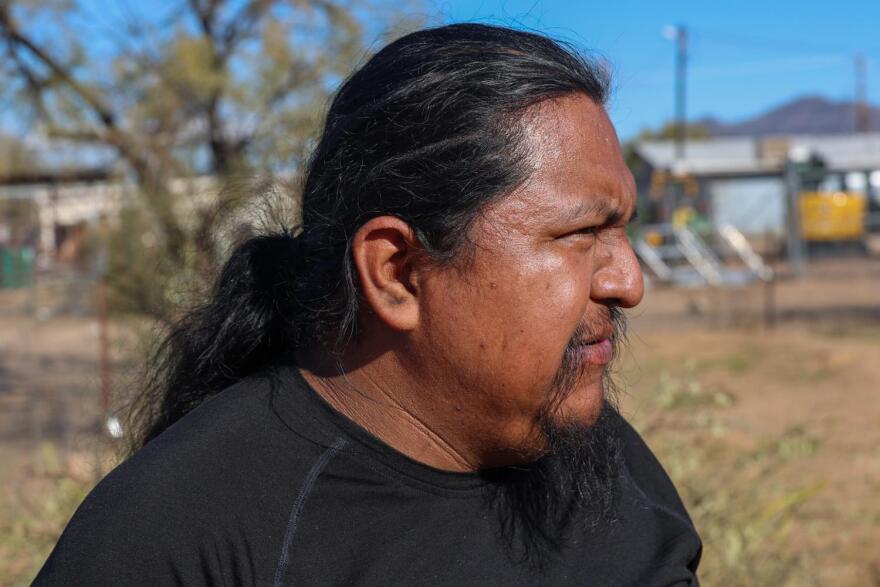 Man with long hair looks out