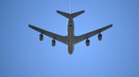 A U.S. Air Force KC-135 Stratotanker aerial refueling aircraft performs a flyover during the national anthem before an NCAA college football game.