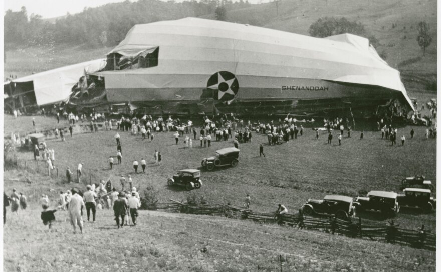 Distant view of the wreckage of the U.S. Navy USS Shenandoah (ZR-1), 1925, with many local spectators and automobiles.