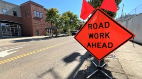 A road sign announcing road work ahead.