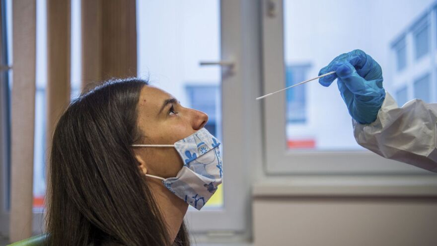 A medical student takes a nose swab sample for the novel coronavirus COVID-19 from a staff member.