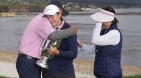 Allisen Corpuz is hugged by her parents after winning the U.S. Women's Open golf tournament at the Pebble Beach Golf Links, Sunday, July 9, 2023, in Pebble Beach, Calif. (AP Photo/Darron Cummings)