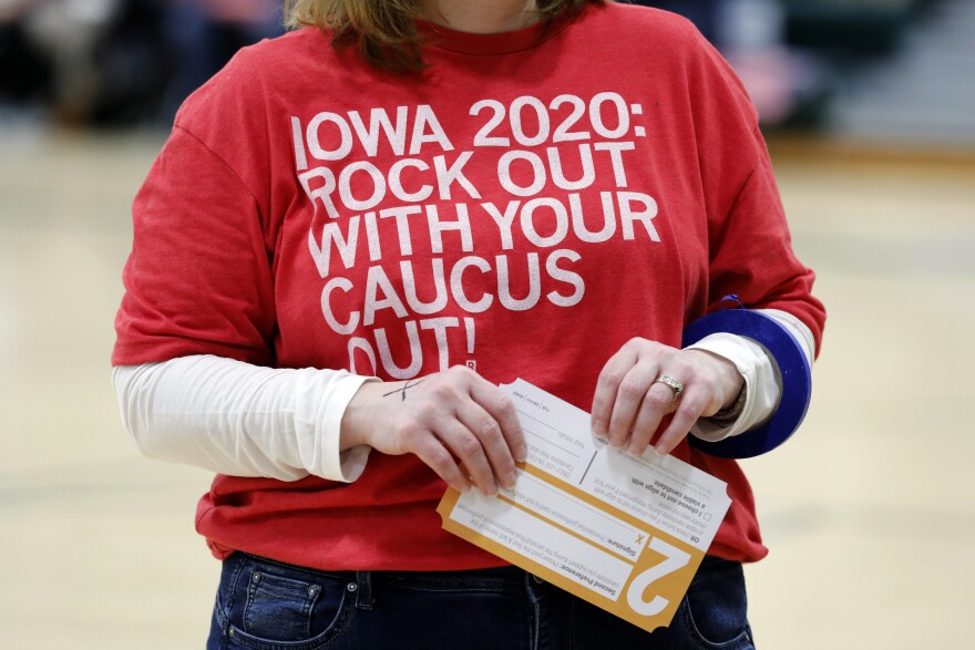 A local resident holds a Presidential Preference Card during an Iowa Democratic caucus at Hoover High School, Monday, Feb. 3, 2020, in Des Moines, Iowa.