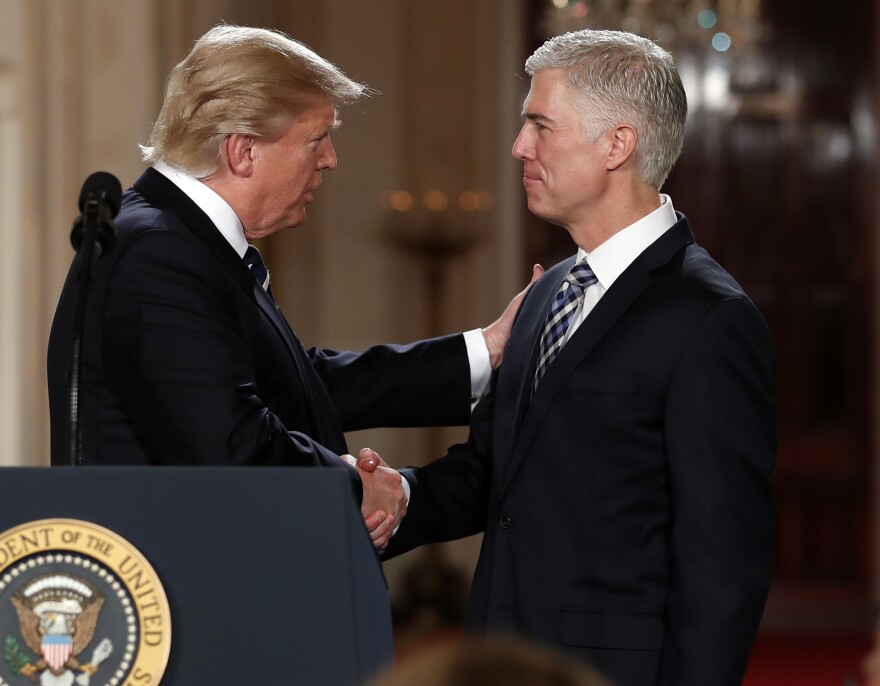 President Donald Trump shakes hands with 10th U.S. Circuit Court of Appeals Judge Neil Gorsuch, his choice for Supreme Court associate justice in the East Room of the White House in Washington, Tuesday, Jan. 31, 2017. 