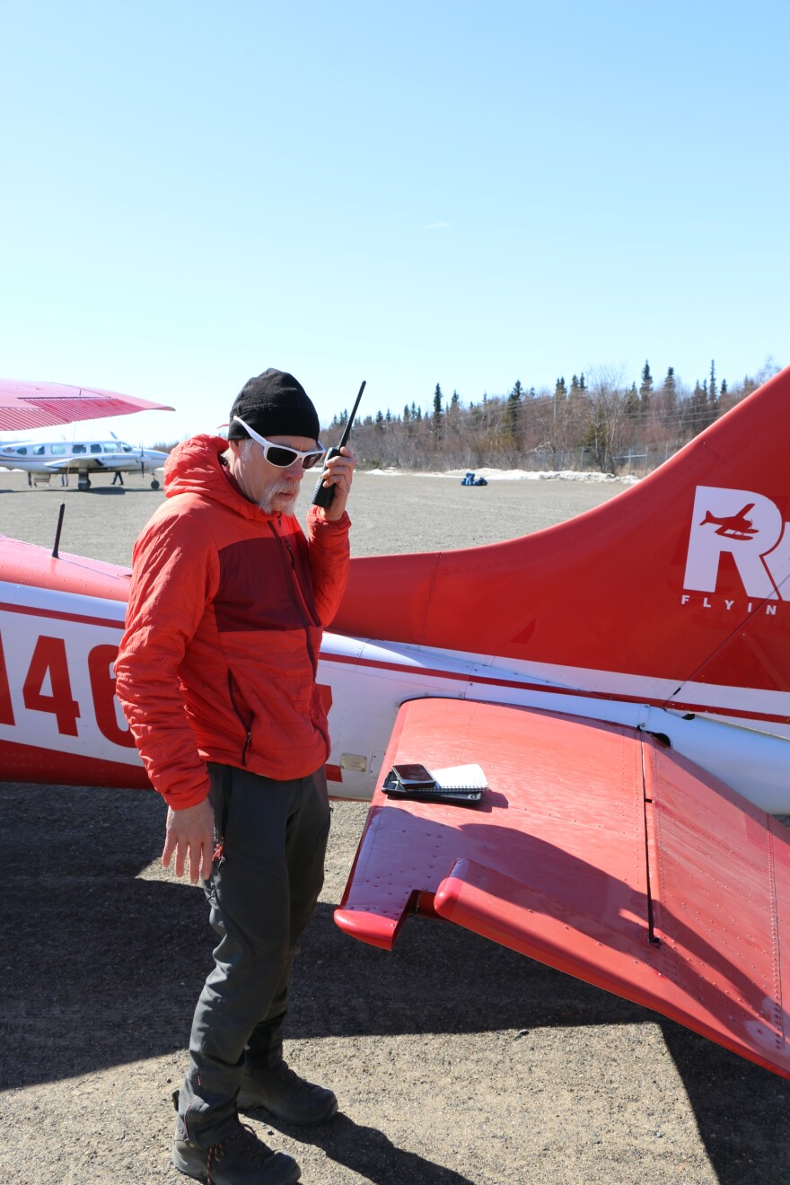 National Weather Service Hydrologist Johnse Ostman radios out to community members along the Kuskokwim River from the Lower Kalskag airstrip on May 8, 2026. 