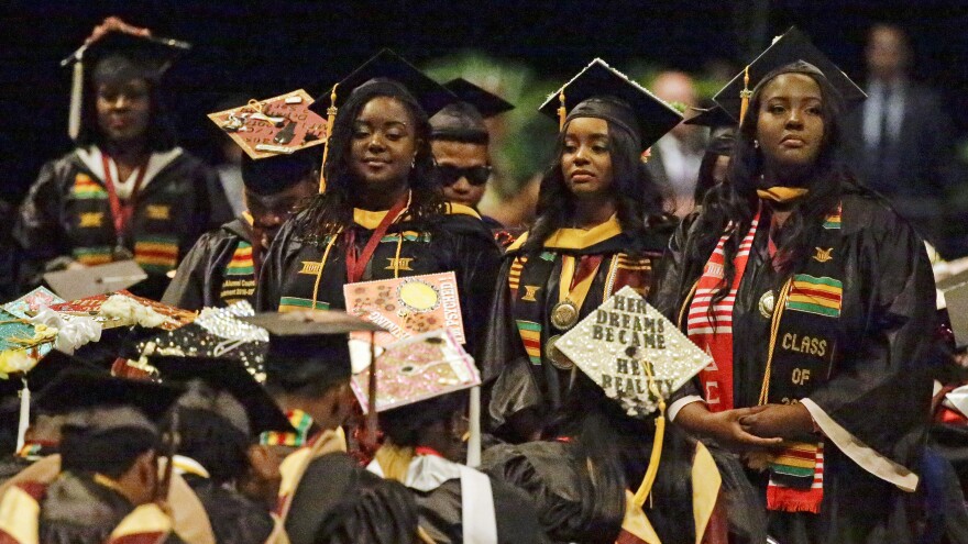Students stand and turn their backs on DeVos during her commencement speech at Bethune-Cookman on Wednesday.