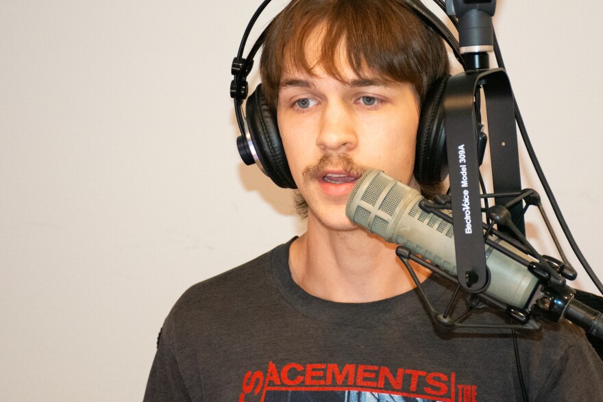 A person wearing headphones, talking into a microphone