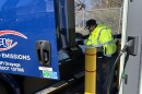 Truck driver Mohamed Jomni charges one of NFI's new electric trucks at a warehouse in Chesapeake on Thursday, Jan. 22, 2026.