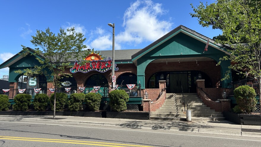 A larger green building with a sign reading "Harper's"
