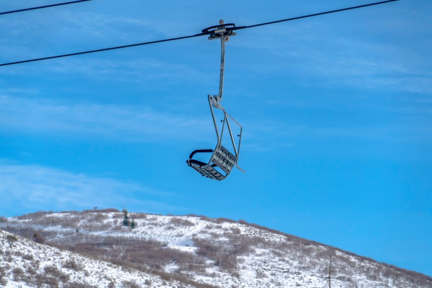 Chair lift over a snowy mountain at a ski resort in Park City, Utah.