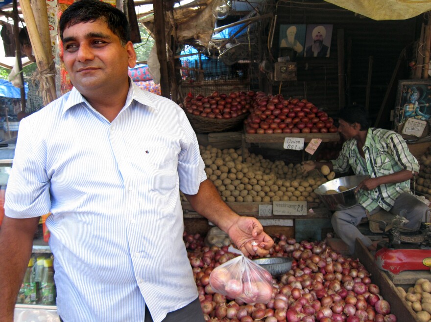 While shopping at a vegetable stand, wedding videographer Mohammad Saleem said his financial condition now is "earning and burning."