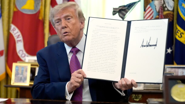 President Donald Trump holds up a signed executive order in the Oval Office of the White House, Thursday, Aug. 27, 2026, in Washington.