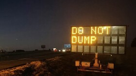 A sign on I-35 near the Stillwater exit warns drivers to not dump their grain trailers.
