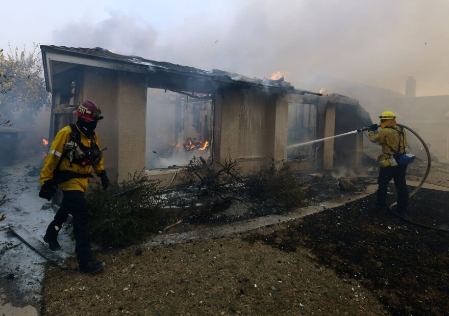 Firefighters try to save a house during the Thomas Fire in Ventura, Calif. on Dec. 5, 2017. (Mark Ralston/AFP/Getty Images)