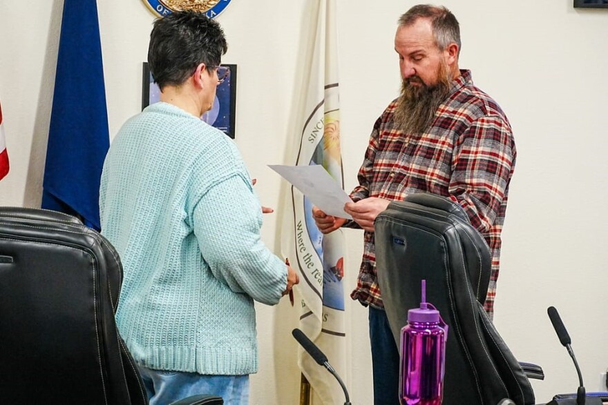 two people talk in a meeting room