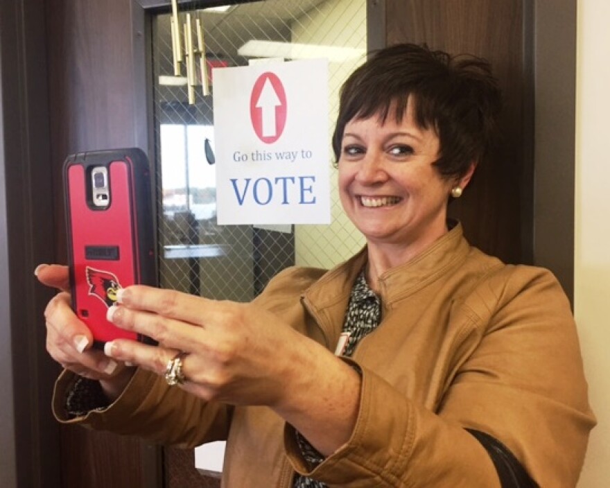 Voter taking a selfie photo outside polling area
