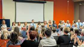 Nursing graduates stand and take a pledge 